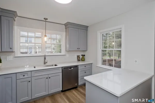 a kitchen with a sink a window and cabinets