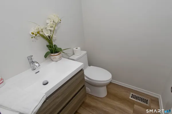 a bathroom with a sink a toilet and vanity