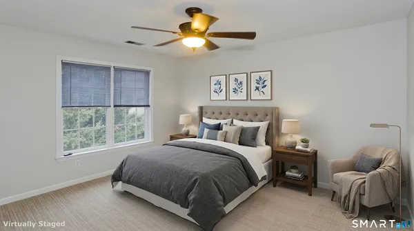 a bedroom with a bed couch and window