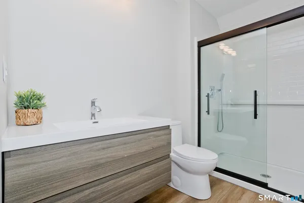 a bathroom with a toilet and a shower