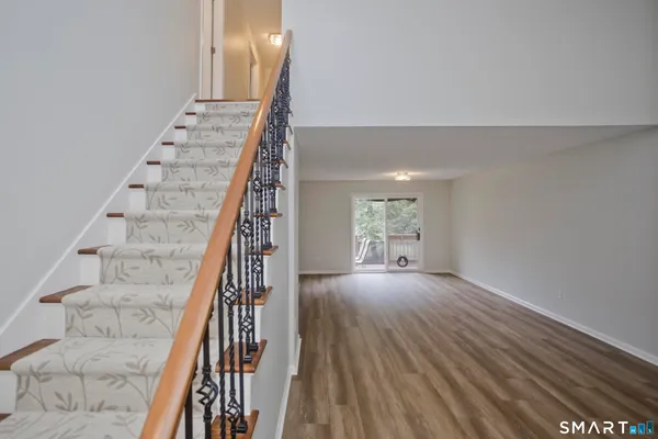 a view of an entryway with wooden floor