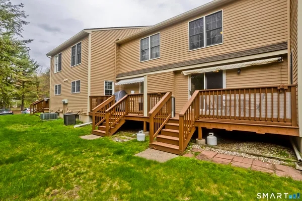 a view of a house with a yard and deck