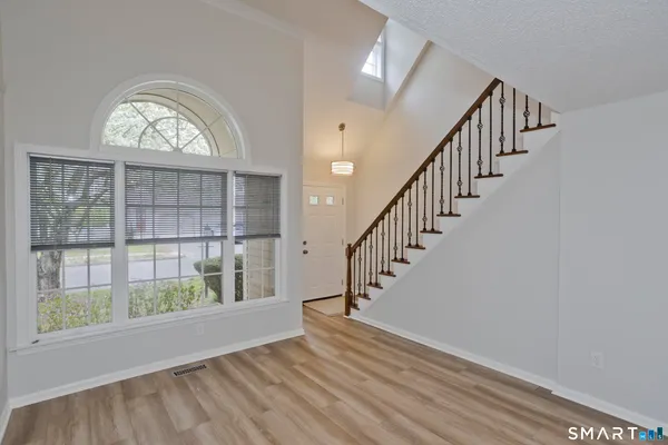 a view of an entryway with wooden floor