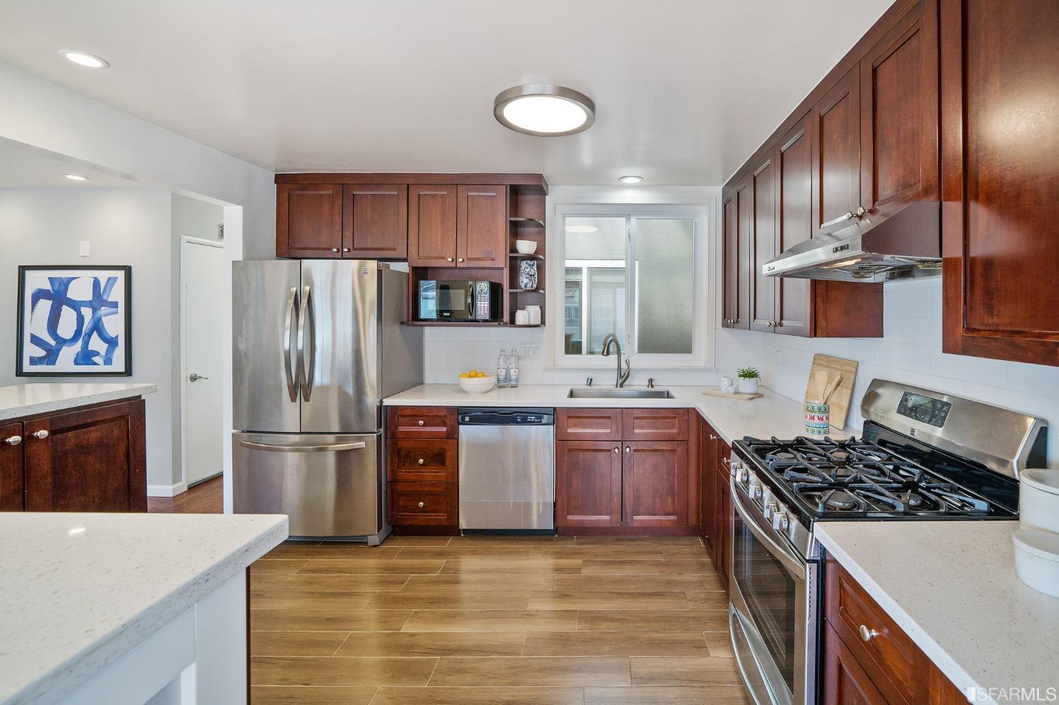 67 Marshall Way Daly City, CA 94014 - Photo 17 of 42 a kitchen with stainless steel appliances granite countertop a refrigerator stove and oven