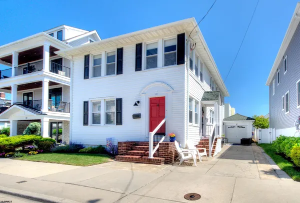 a front view of a building with a yard