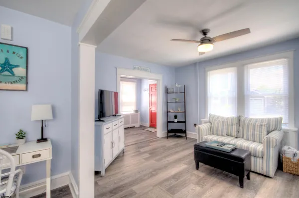 a living room with furniture wooden floor and a table