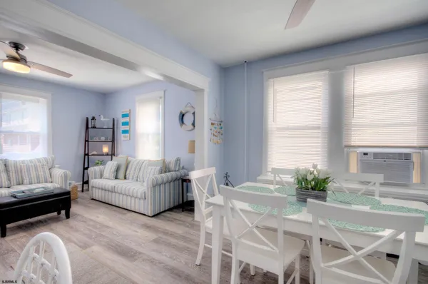 a view of a dining room with furniture and wooden floor