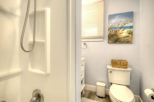 a bedroom with a bed and a lamp on dresser