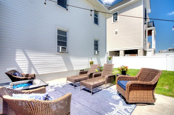 a front view of a house with a yard and potted plants