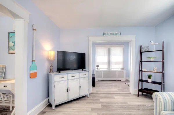 a living room with furniture and a wooden floor