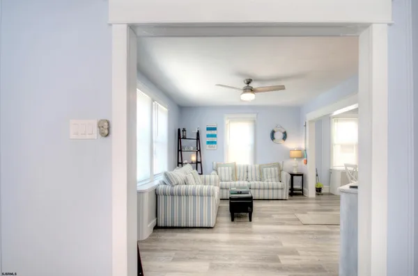 a living room with furniture and wooden floor
