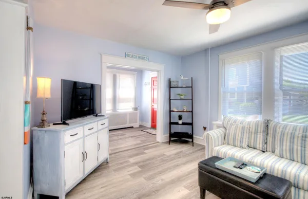 a dining room with furniture and wooden floor