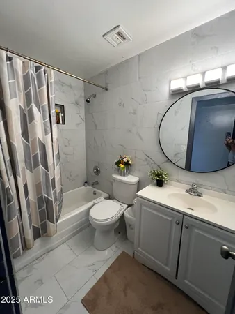 a bathroom with a bathtub and shower