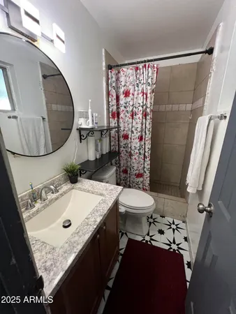 a room with a bed and a dresser