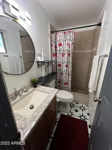 a room with a bed and a dresser