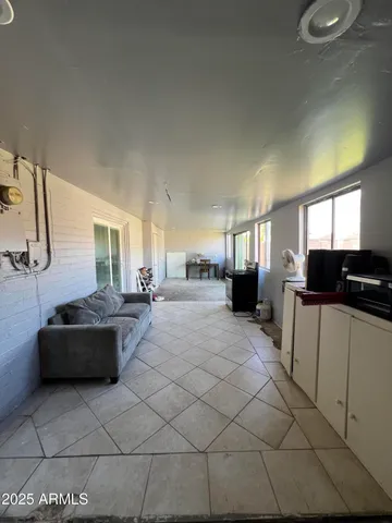 a living room with couches and furniture with kitchen view