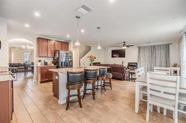 a view of a kitchen with dining room and wooden floor