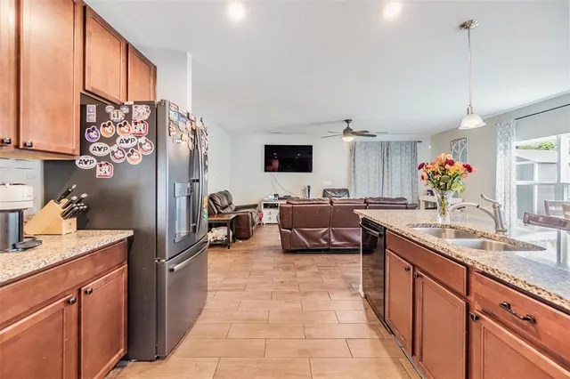 a large kitchen with stainless steel appliances granite countertop a sink counter space and a window