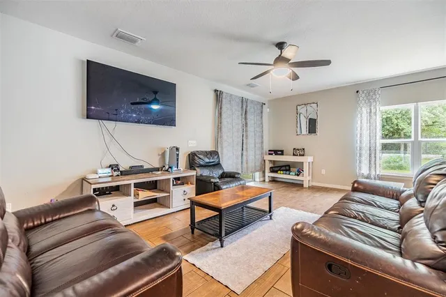 a living room with furniture a table and a window