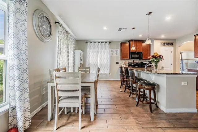 a view of a dining room with furniture window and wooden floor