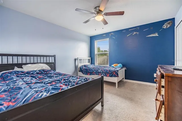 a bed room with a bed and a chandelier