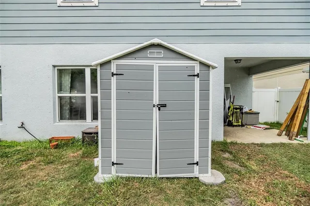 a view of wooden door and a window