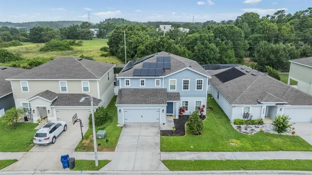 an aerial view of a house with a yard