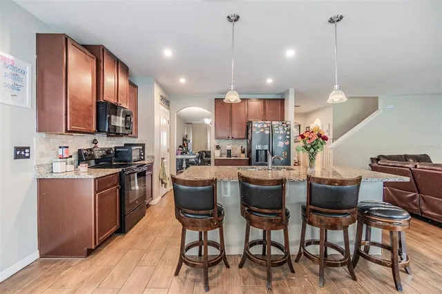 a kitchen with cabinets and chairs