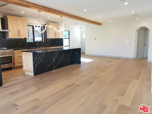 a large kitchen with a sink and cabinets