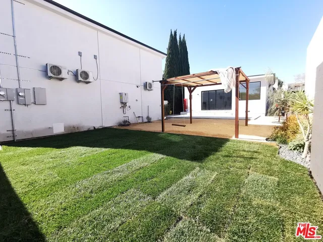 a view of a patio with table and chairs