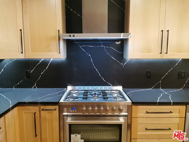 a stove top oven sitting inside of a kitchen