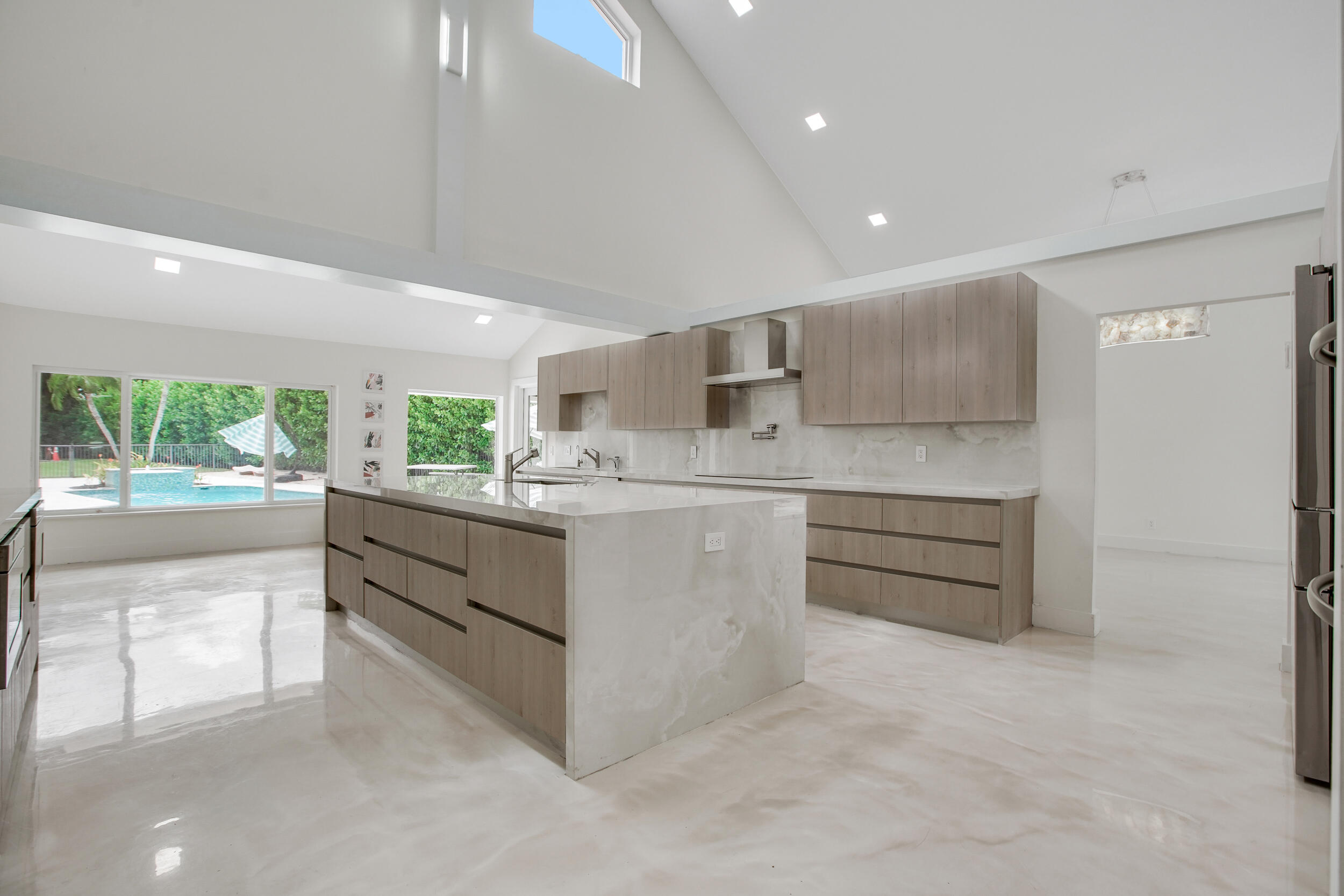 7351 Valencia Drive Boca Raton, FL 33433 - Photo 13 of 39 a kitchen with stainless steel appliances kitchen island granite countertop a refrigerator and a stove top oven