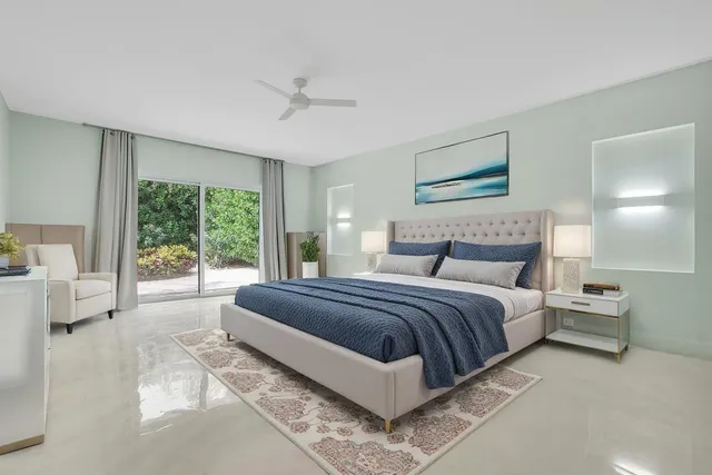 a spacious bedroom with a bed and a large window