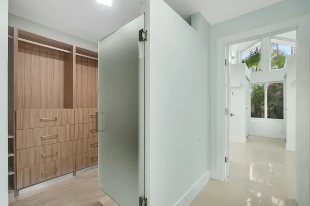 a view of hallway with window and doors