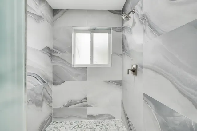 a bathroom with a bathtub and shower