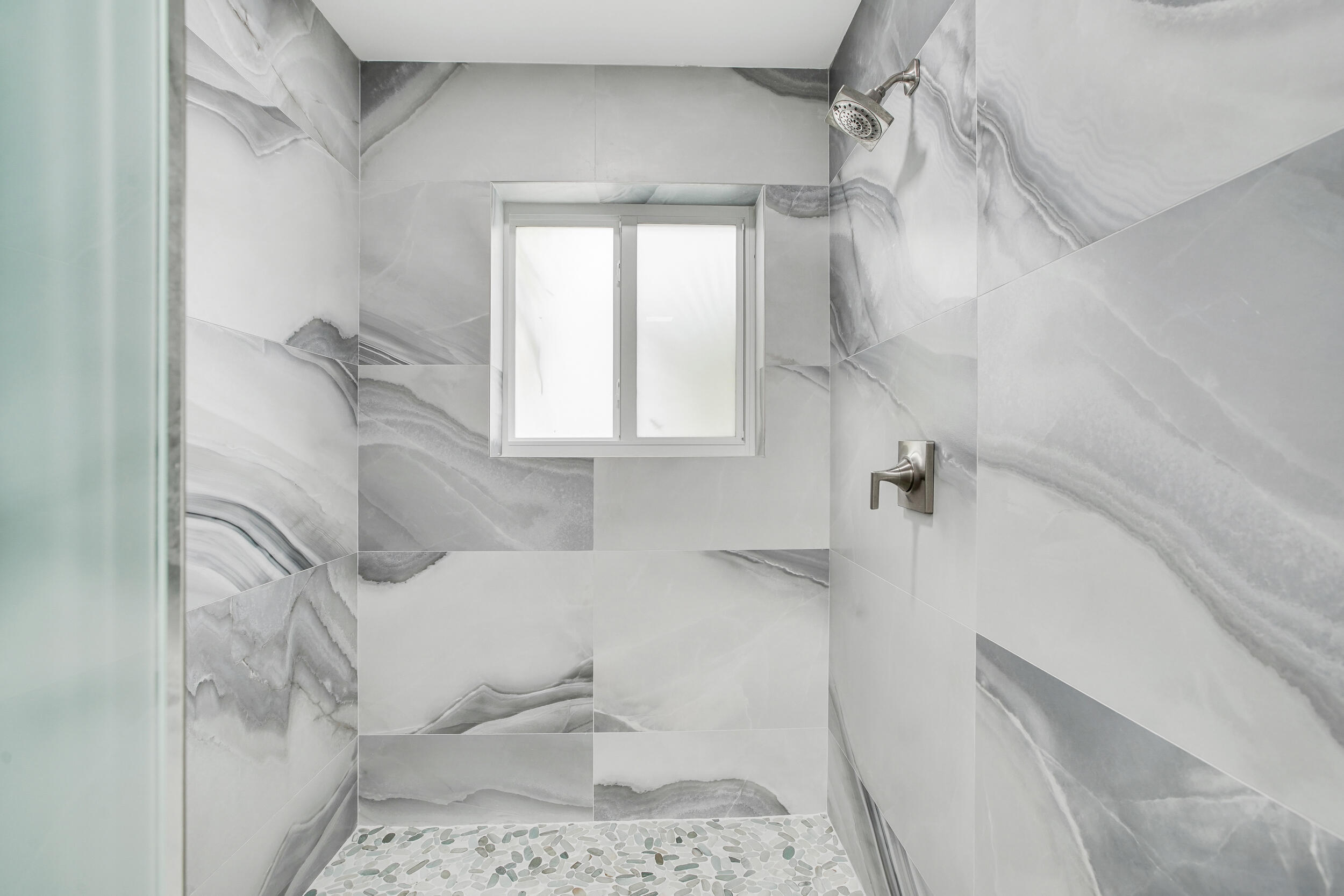 7351 Valencia Drive Boca Raton, FL 33433 - Photo 19 of 39 a bathroom with a bathtub and shower