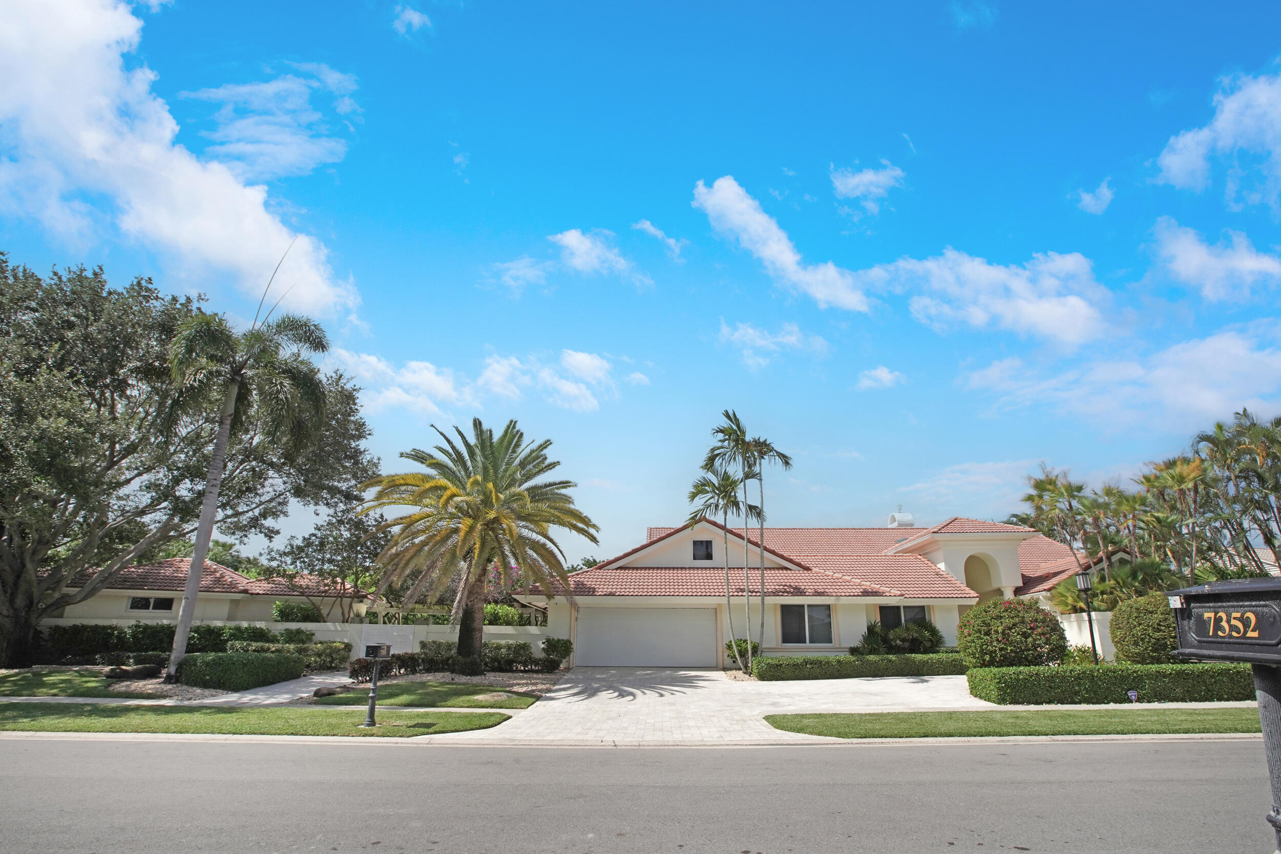 7351 Valencia Drive Boca Raton, FL 33433 - Photo 2 of 39 a front view of a house with a yard and garage
