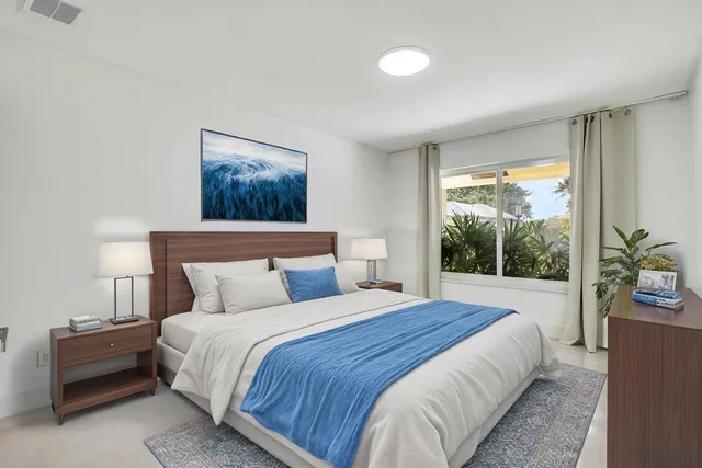 a bedroom with a bed and a painting on the wall