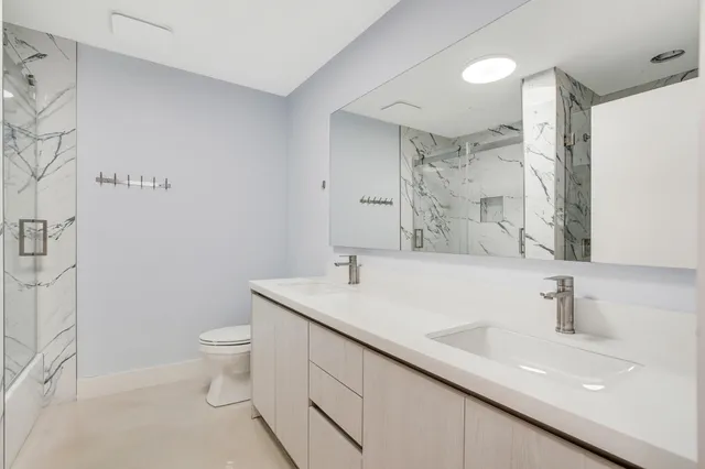 a bathroom with a sink toilet and shower