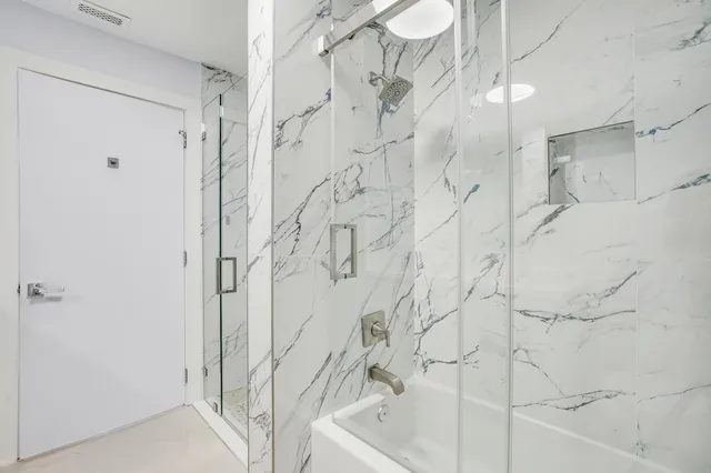 a bathroom with a bathtub and shower