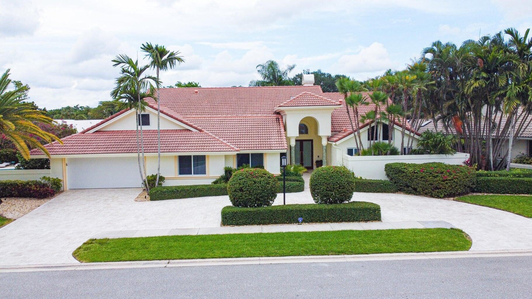 7351 Valencia Drive Boca Raton, FL 33433 - Photo 35 of 39 a front view of a house with garden