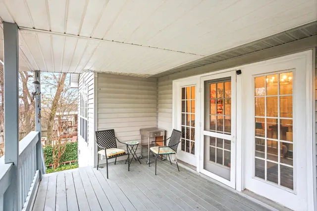 a view of a room with furniture and wooden floor