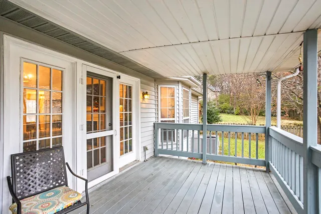 a view of a porch with wooden floor and iron stairs