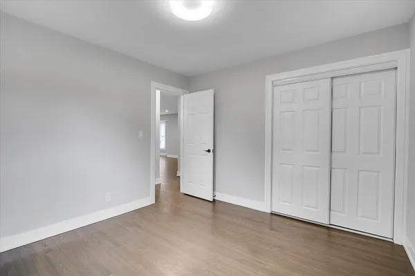 a view of an empty room and wooden floor