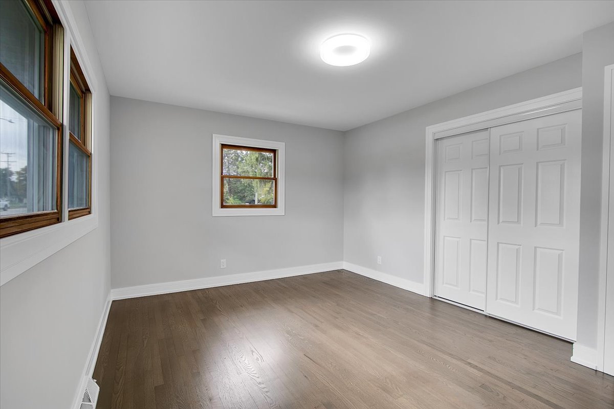 11550 Francis Road Mokena, IL 60448 - Photo 16 of 22 an empty room with wooden floor and windows