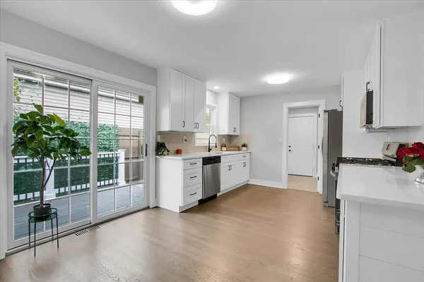 a kitchen with stainless steel appliances a refrigerator sink and cabinets
