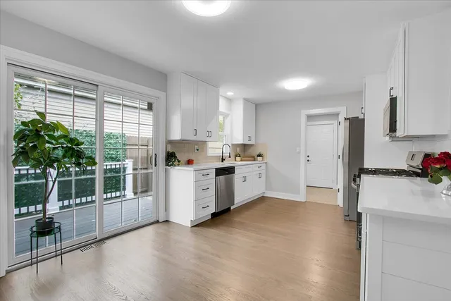 a kitchen with stainless steel appliances a refrigerator sink and cabinets