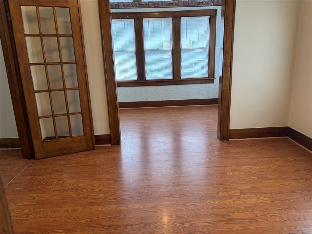 264 Hopwood Fairchance Road Uniontown, PA 15401 - Photo 5 of 19 an empty room with wooden floor and windows