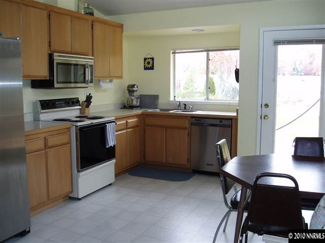 7683 Barnsdale Road Reno, NV 89511 - Photo 2 of 6 a kitchen with a stove a sink and a microwave