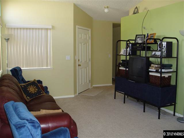7683 Barnsdale Road Reno, NV 89511 - Photo 3 of 6 a living room with furniture and a window